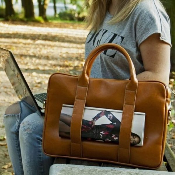 laptop bag next to a woman in the park