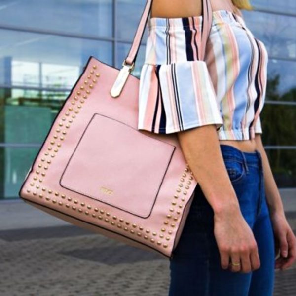 woman holding a pink leather bag