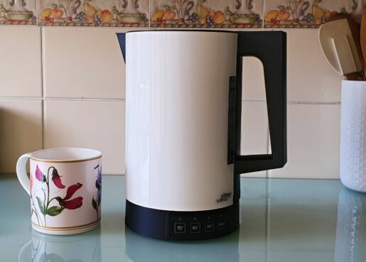 white kettle and a cup on a worktop