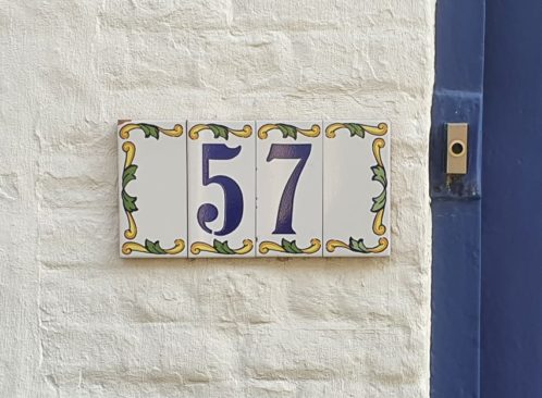 number tiles on the house wall