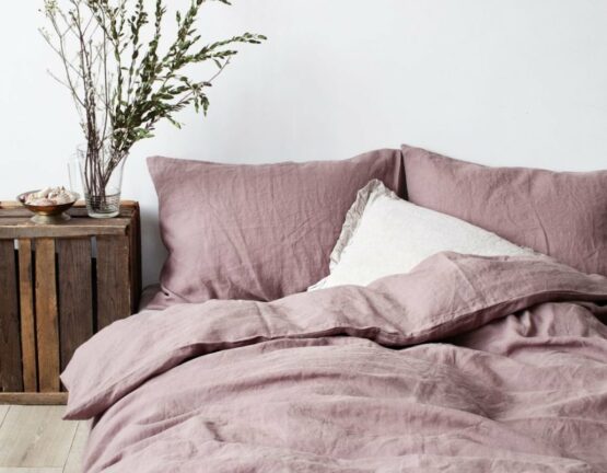 bed with muted colour linen bedding sheets