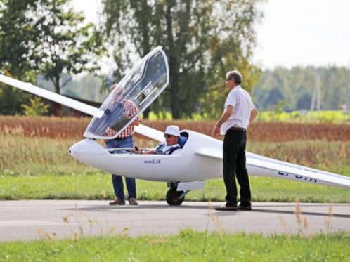 glider on the runway with people