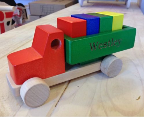colourful wooden toy truck on the desk