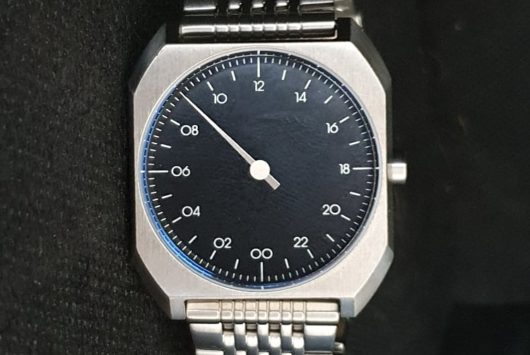 single hand watch - face in the dark background