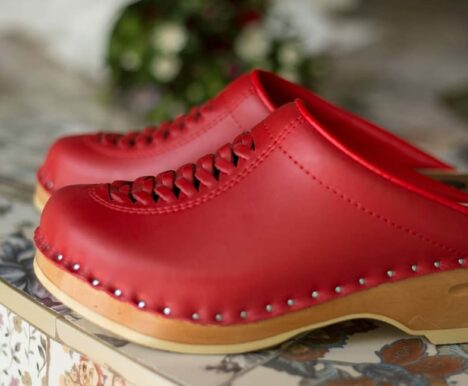 two red leather clogs
