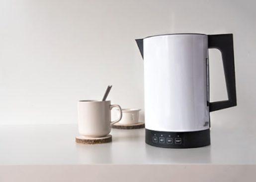 white kettle on the table with a cup